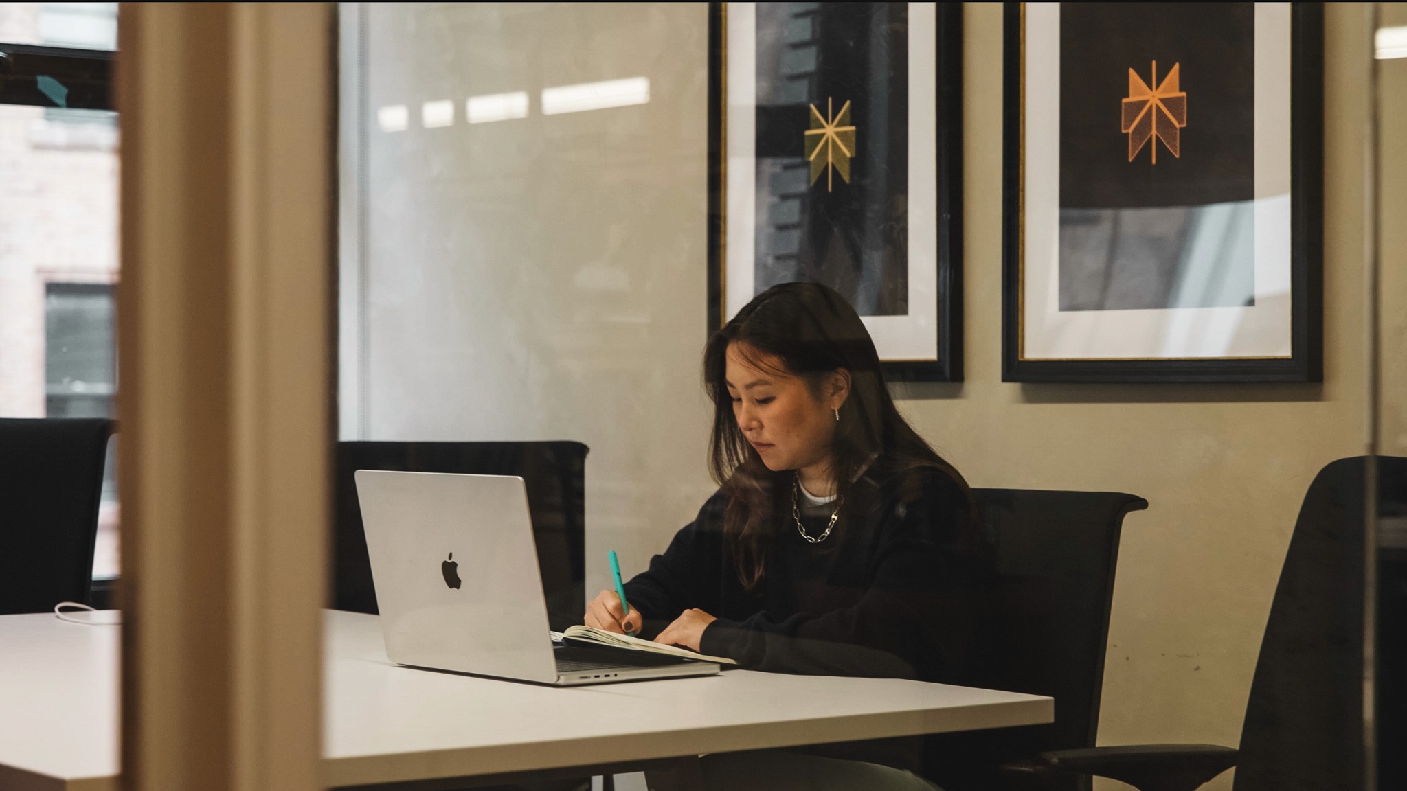 A Perplexity team member working at a laptop in a warmly lit office